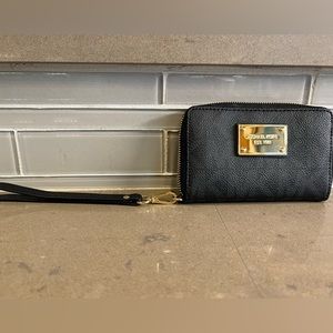 Michael Kors wristlet. 6 inches long by 4 inches tall. Gold accents.
